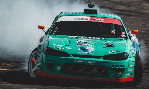 Decals on the body of a turquoise race car